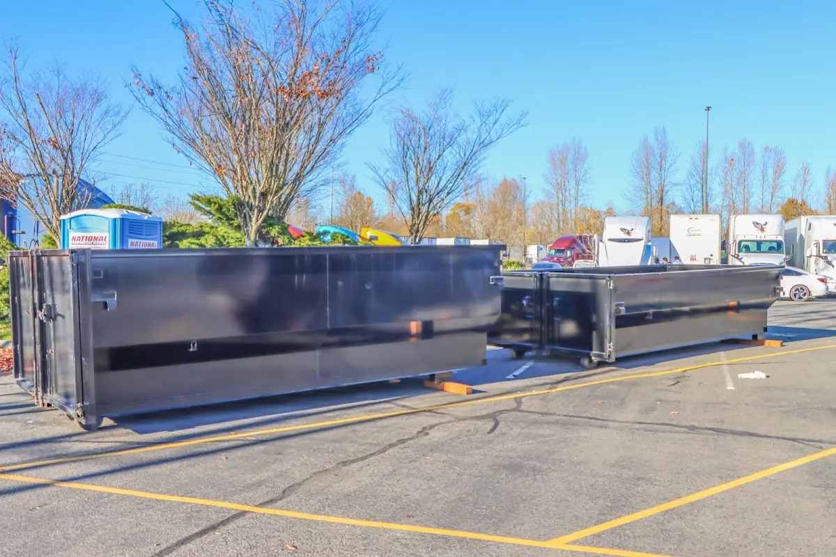 Professional dumpster rental service with roll-off container on residential driveway in East Lyme